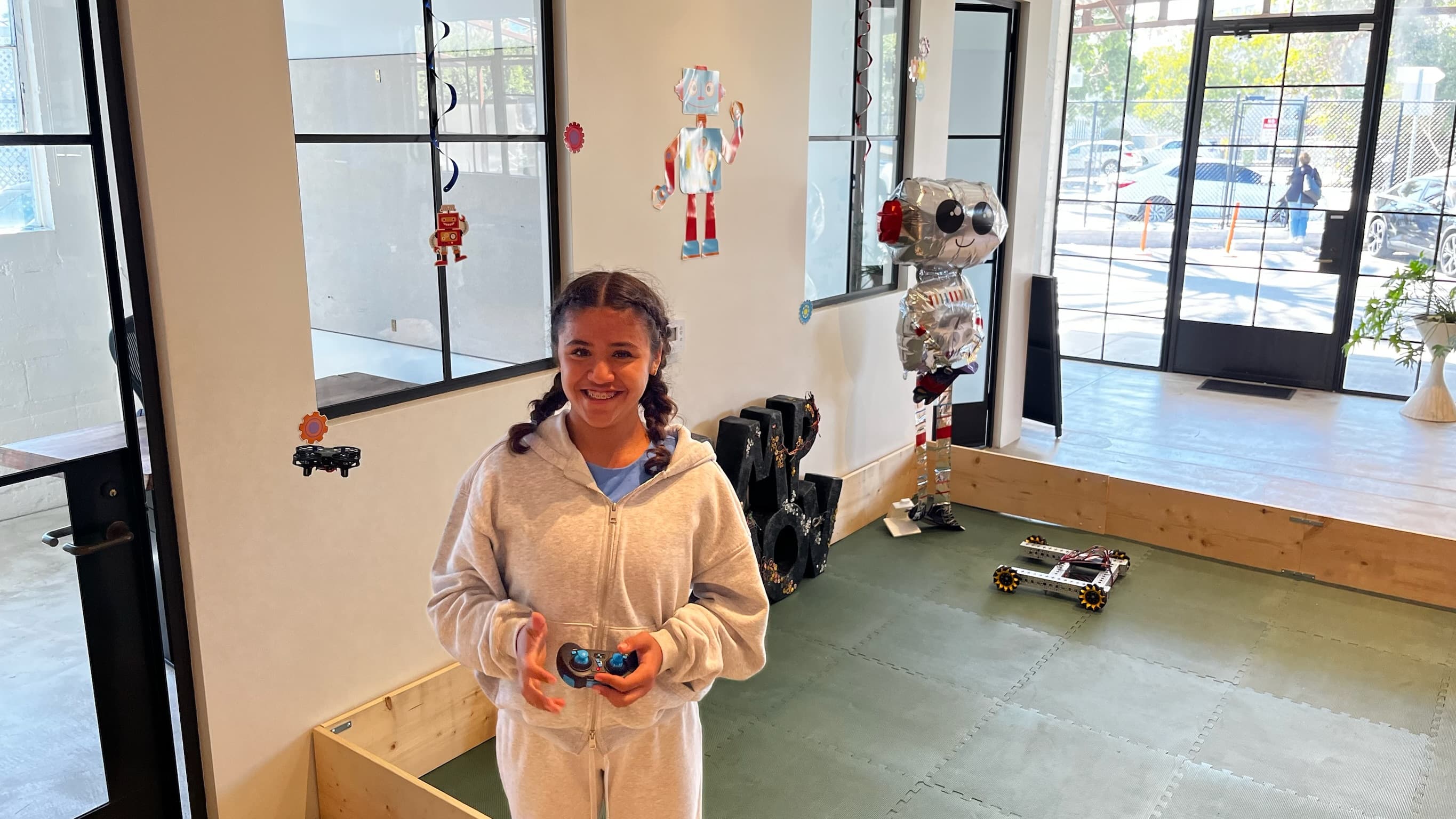 Camp Asimov students testing robots in a robotics workspace
